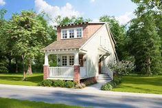 a small white house sitting on top of a lush green field