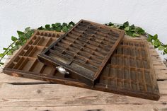 two wooden boxes with compartments on top of each other