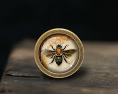 a ring with a bee painted on it