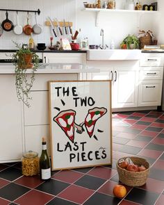 the two last pieces sign is on the kitchen floor next to some fruit and vegetables