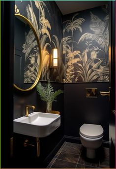 a bathroom with black and gold wallpaper, a white toilet and a plant in the corner