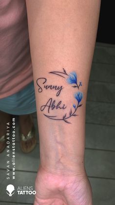 a woman's wrist tattoo with the words sunny aloh and blue flowers on it