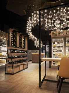 an empty wine cellar with many bottles on shelves and chandeliers hanging from the ceiling