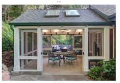 an enclosed patio with table and chairs