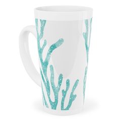 a white coffee cup with blue corals on it