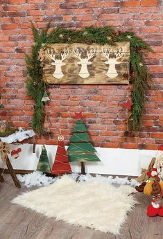 a brick wall decorated with christmas trees and decorations