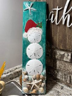 a clock made out of sand sitting on top of a counter next to a sign