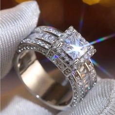 a diamond ring sitting on top of a white cloth