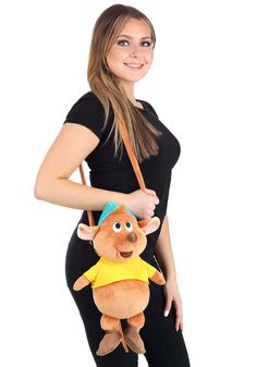 a woman is holding a stuffed toy in her hand