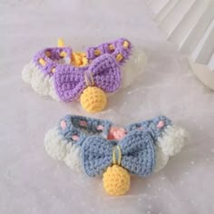 two crocheted hair clips on top of a table