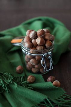 nuts in a glass jar on a green cloth