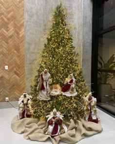 a decorated christmas tree with angels around it