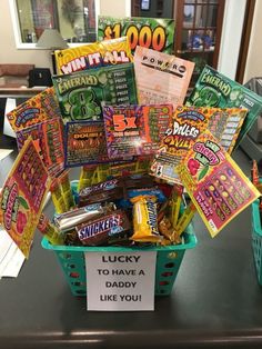 a basket filled with lots of candy sitting on top of a table next to a sign