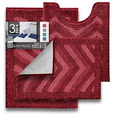 two bathroom rugs, one in red and the other in white with an arrow design