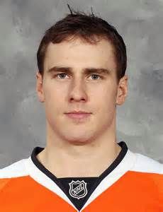 a man in an orange and white hockey jersey