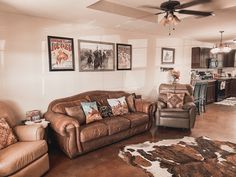 a living room filled with furniture and pictures on the wall