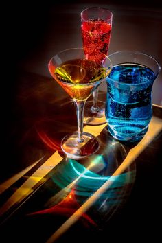 two glasses filled with liquid sitting on top of a table