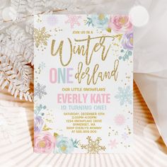 a snowflake themed birthday party with gold foil and pink flowers on the front