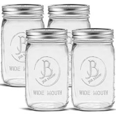 four mason jars with lids and labels on them