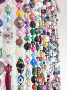 a bunch of beads hanging from the side of a wall