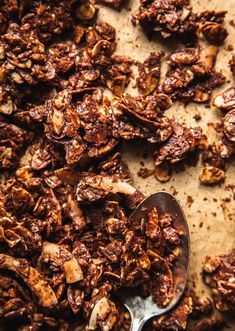 a spoon full of granola sitting on top of a table