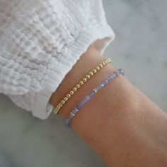 Add a special touch to your look. Our Birthstone Bead Collection styles are crafted with natural stones and three 14k gold rondelles strung on a coated wire for maximum durability. Wear your own birthstone—or a loved one’s—for a meaningful layer in any bracelet stack. Tanzanite is December's birthstone. Beaded Stacking Bracelets, Simple Bracelet Designs Gold, Birthstone Beaded Bracelets, 14k Gold Filled Yellow Gold Bracelets With Birthstone, 14k Yellow Gold Filled Birthstone Bracelets, 14k Gold-filled Yellow Gold Bracelets With Birthstone, 14k Gold-filled Yellow Gold Beaded Bracelets, 14k Gold-filled Faceted Bead Bracelets As Gifts, 14k Gold Filled Faceted Beads Bracelet As Gift