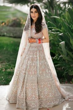 a woman in a wedding dress posing for the camera