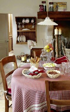 a dining room table with plates and bowls on it