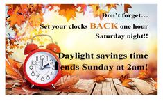 an alarm clock sitting on top of a wooden table next to leaves and the words daylight savings time ends sunday at 2aam