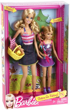 two barbie dolls are in a pink box