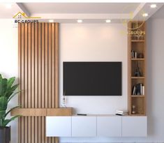 a living room with a large television mounted on the wall next to a potted plant