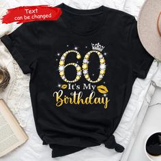 a black shirt with the words 60th birthday on it and a crown in gold letters