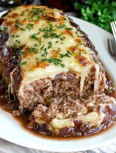 meatloaf covered in gravy and garnished with parsley on a white plate