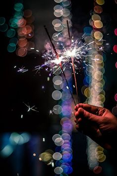 a person holding a sparkler in their hand