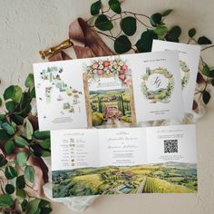 the wedding program is displayed on top of some papers with flowers and greenery around it