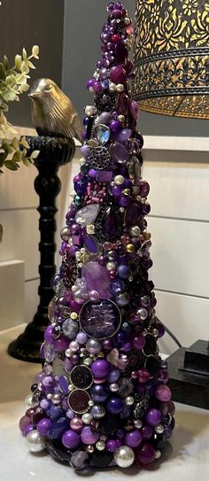 a purple christmas tree sitting on top of a table