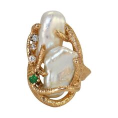 One 14k yellow gold freeform baroque freshwater pearl ring. There are two pearls one overlapping the other. They are set in a branch like design. There are three small diamonds down the side, with one small emerald. The size of the ring is 7 3/4. The top of the ring is a little larger than 1" when on your finger. The diamonds are 0.02ct each, making the three diamonds equal 0.06ctw. and the emerald measures 2.8mm. There is 36mm from bottom to top of ring. This ring weighs 12.7gr. total. This pea Yellow Gold Gemstone Rings, Pearl Cocktail Ring, Modern Wedding Rings, Garnet And Diamond Ring, Gold Baroque, Freshwater Pearl Ring, Pearl And Diamond Ring, Coin Jewelry, Rare Coins