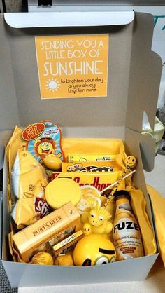 a box filled with lots of different types of food and drinks on top of a table