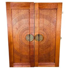 two wooden doors with circular designs on them