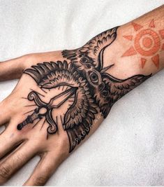 a person's hand with a tattoo on it