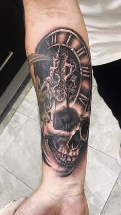 a man's arm with a clock and skull tattoo on it