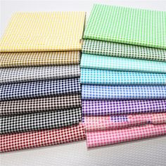 six different colored gingham cloths stacked on top of each other in rows