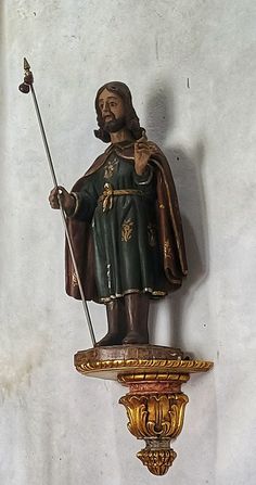 a statue of a man holding a staff