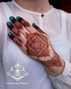 a woman's hand with henna on it