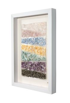 a white frame with multicolored paper in it