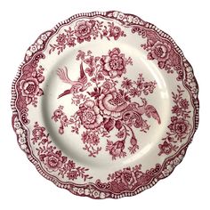 an old red and white plate with flowers on the rim, has birds in flight