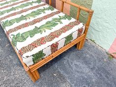 a wooden bench sitting next to a green wall