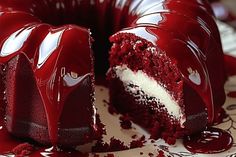 a red velvet cake with white frosting and sprinkles on a plate