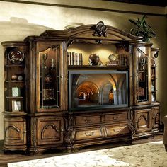 a large entertainment center with glass doors on the front and side shelves in an ornate style