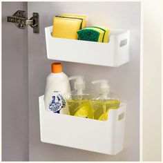 two white plastic containers with cleaning products and soaps in them on a door handle